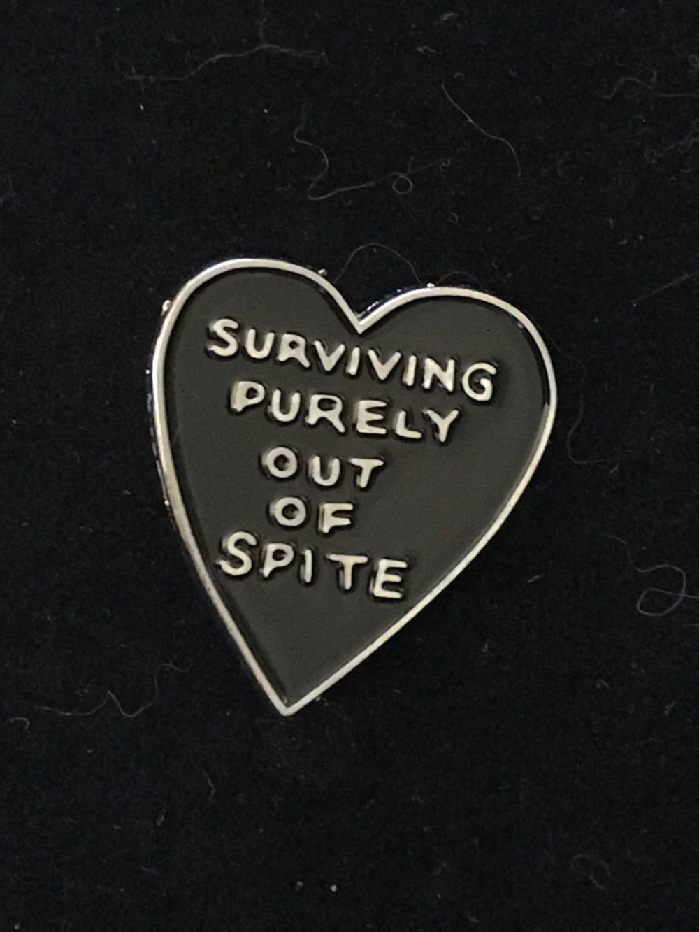 NWOT black heart “Surviving purely out of spite” pin (pins: 1/$12, 2/$20)